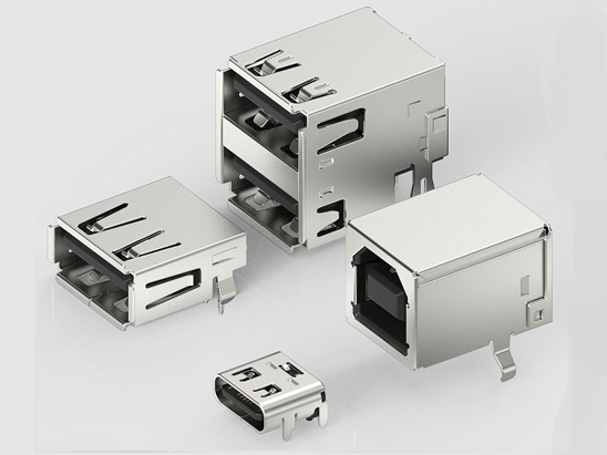 Four USB receptacle components on a pale grey background