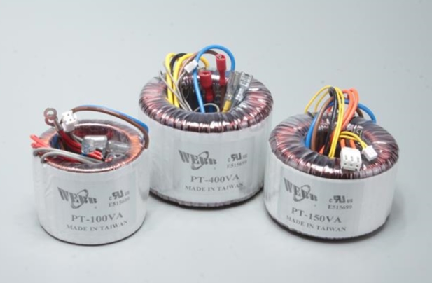 Three toroidal transformers against a light grey background